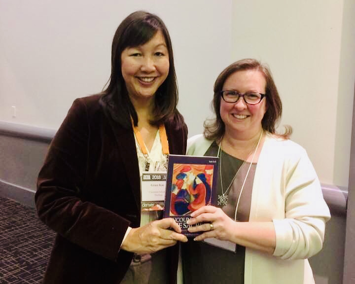 Grace & Toddie holding our book.